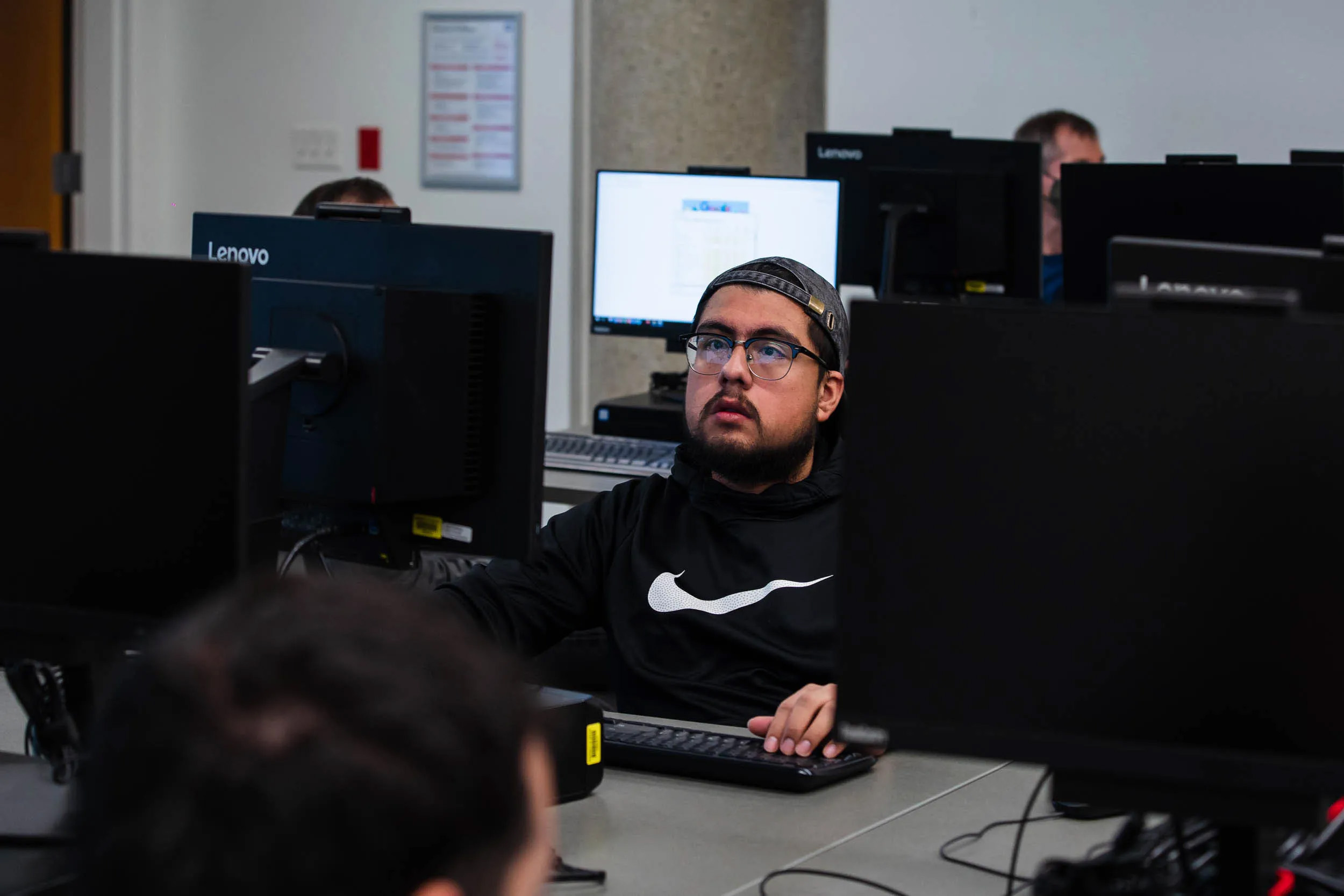 A Student listens to Professor David Kennemer during a cyber security class at San Diego City College on Nov. 29, 2022. / Photo by Ariana Drehsler
