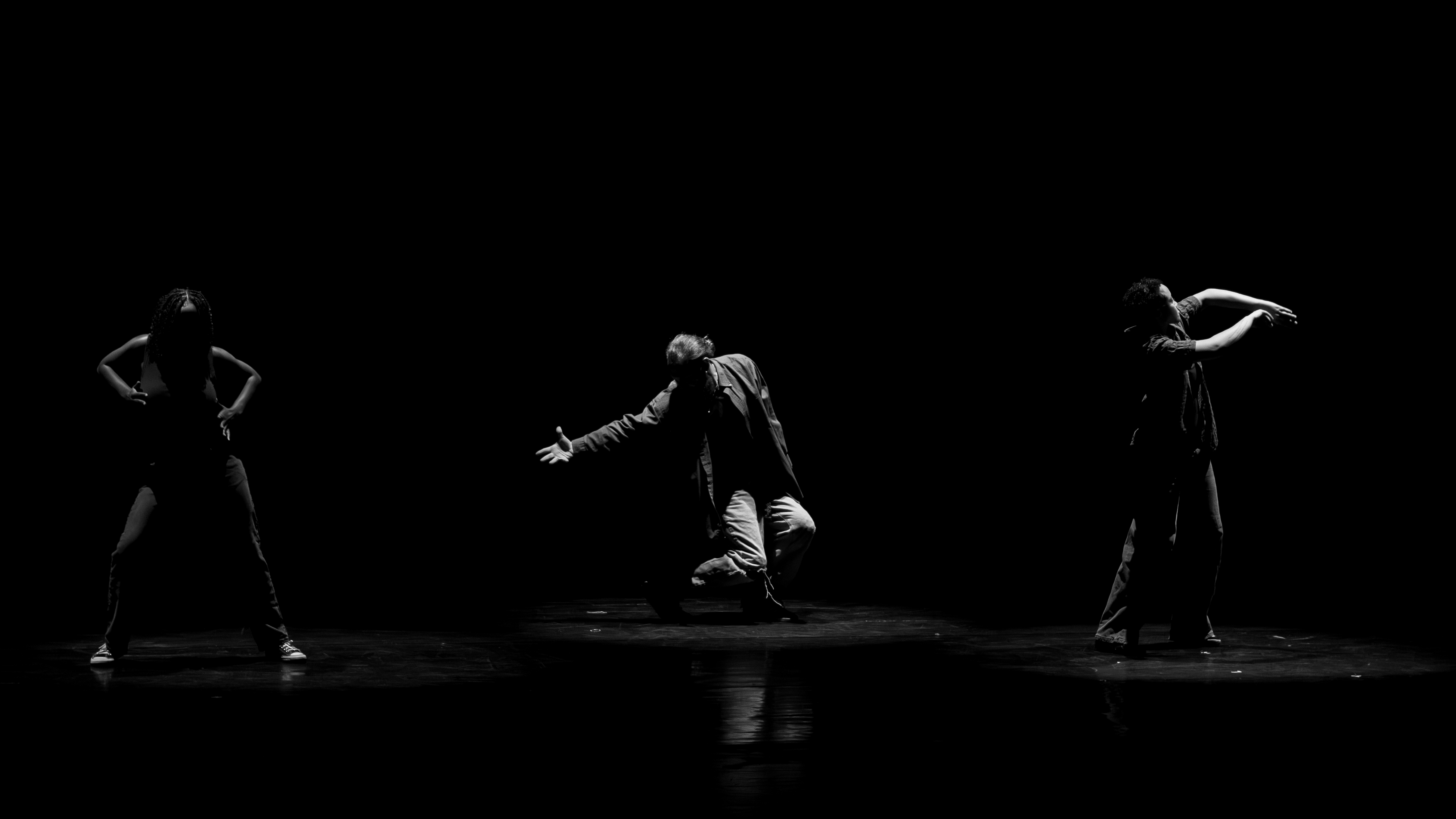 Black and White of 3 dancers posing.