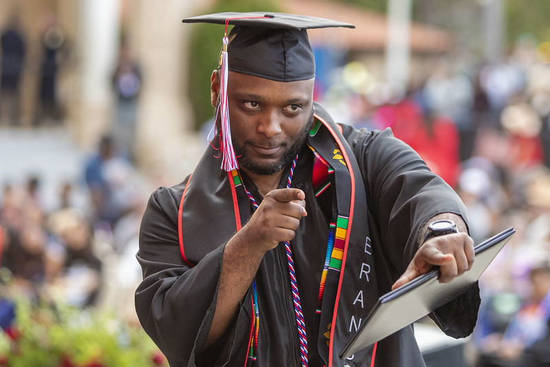 Man pointing at graduation