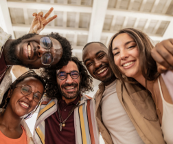 students with heads together smiling