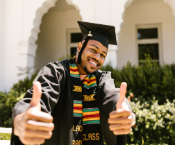 Picture of an HBCU graduate with thumbs up