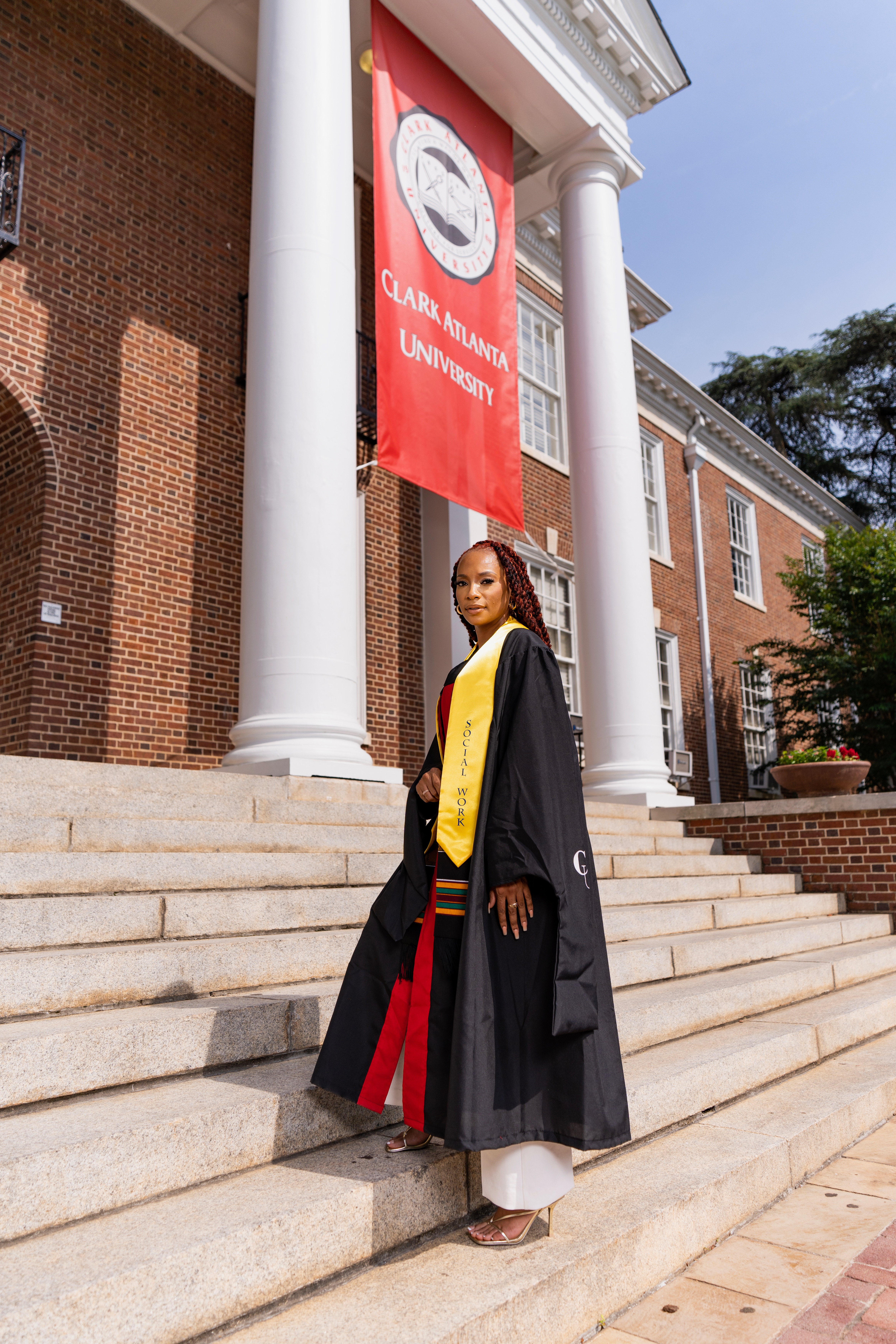 HBCU Woman Graduate posting on steps