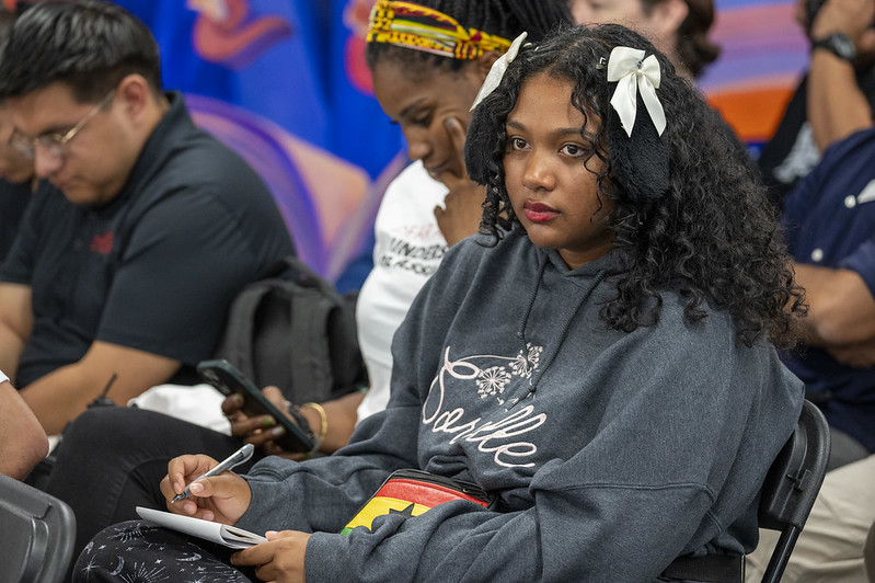 Student taking notes and listening