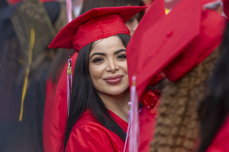 student in red cap and gown