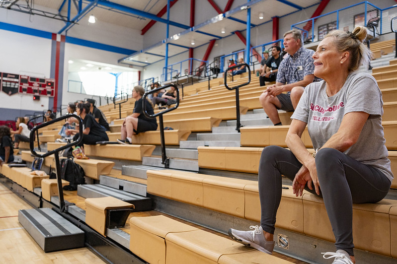 fans on the bleachers in a gym