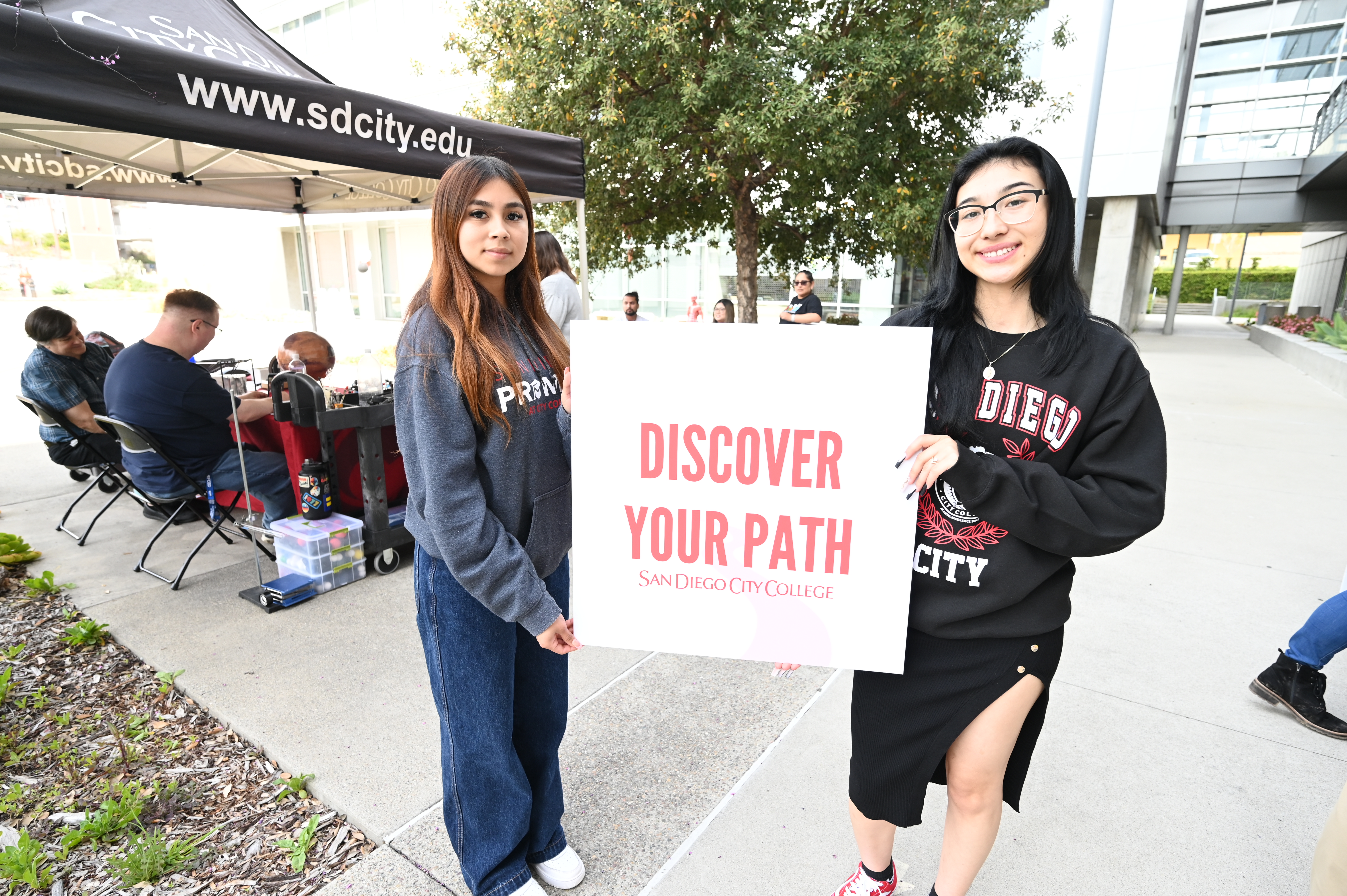 San Diego City College students with you belong signs