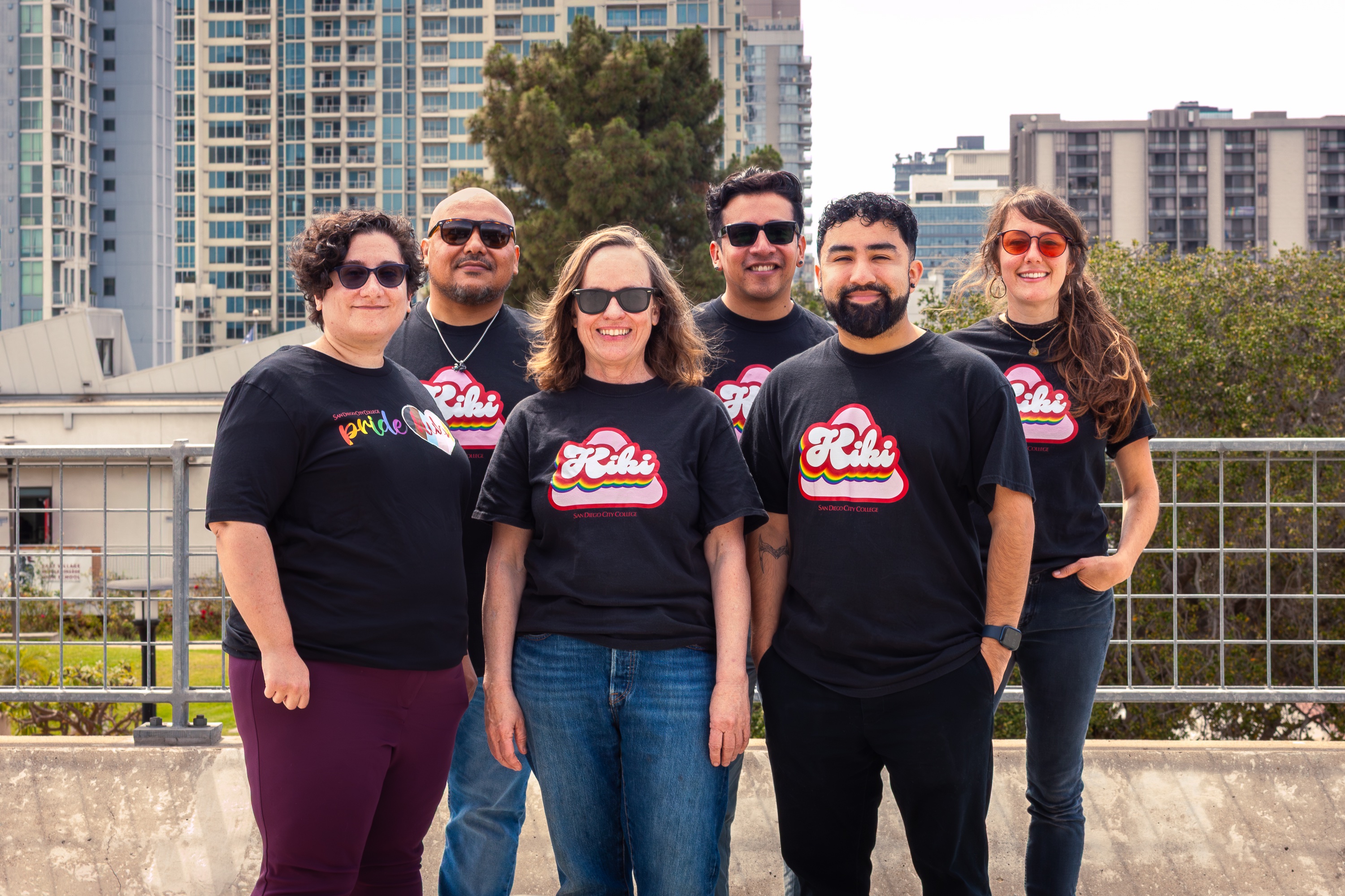 group of individuals with matching black t-shirts with the colored Kiki logo