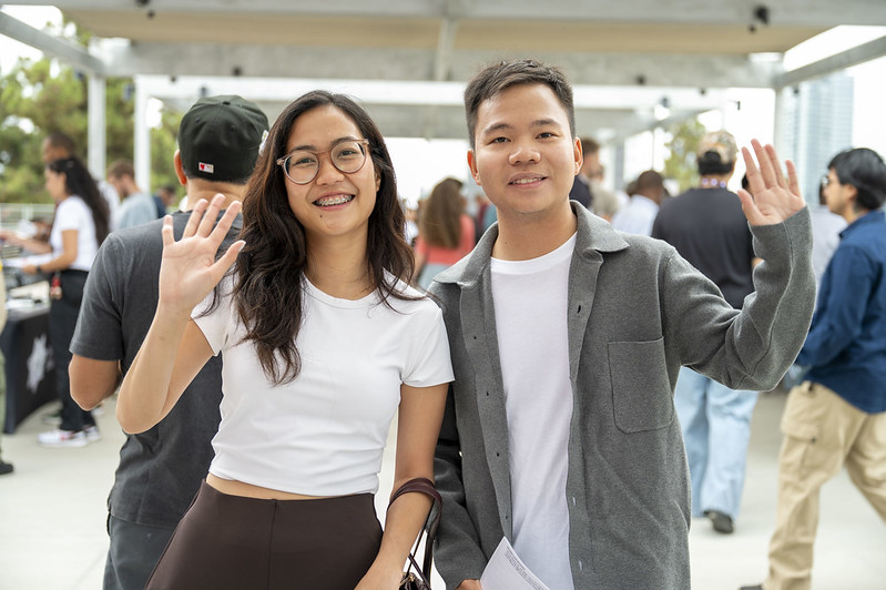 Students waving at the camera